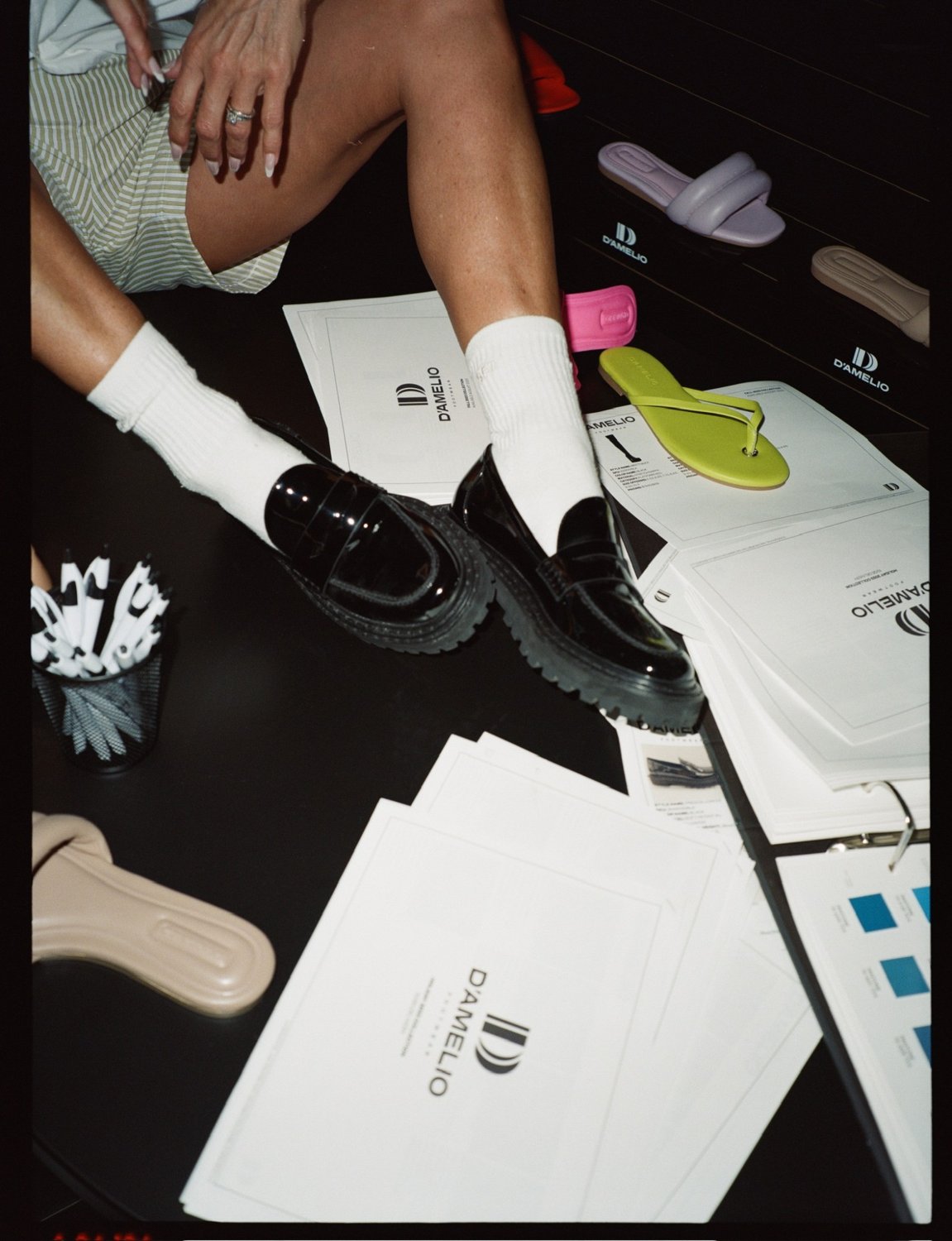 Line sheets and samples on the D'Amelio Footwear showroom desk